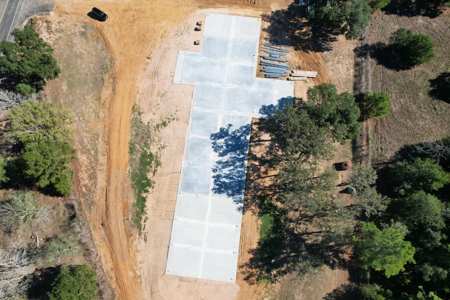 aerial view of concrete slab foundation for 50x235 metal building near Columbus Texas